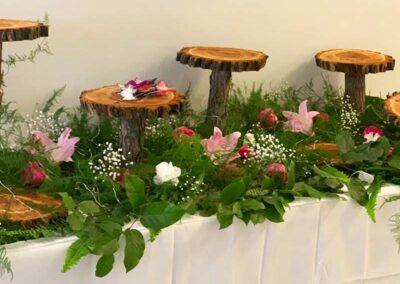 Modern floral arrangement with fresh flowers and wooden elements; ideal for wedding, corporate, and social events in Orange County.