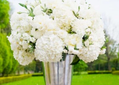 White floral arrangement in a tall silver vase, perfect for wedding flowers and social events in Orange County.