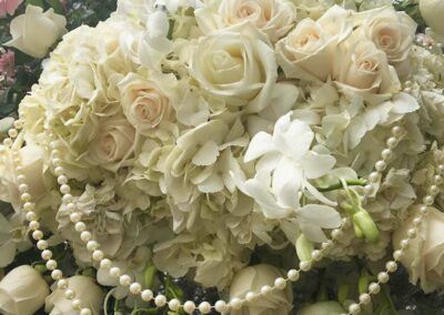 Modern floral arrangement with white roses and pearls, ideal for weddings, corporate, and social events in Orange County.