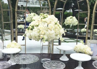 Elegant white floral arrangements in glass vases for a wedding or event in Orange County, offering modern and affordable flower design services.