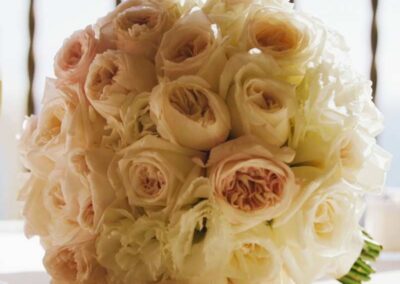 Elegant bridal bouquet with white and peach roses, perfect for wedding flowers in Orange County.