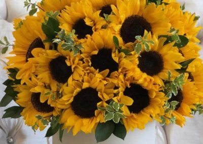 Beautiful arrangement with sunflowers in a glass vase.