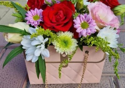 Beautiful arrangement, with roses and seasonal fillers in a cardboard purse. Very beautiful and elegant.