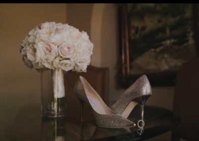 Beautiful bouquet with white roses and a soft pink shown with special shoes for the bride and a ring with diamonds